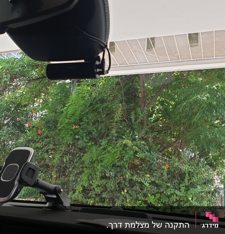תושבת טלפון לרכב ומצלמת דרך מותקנים על השמשה הקדמית.